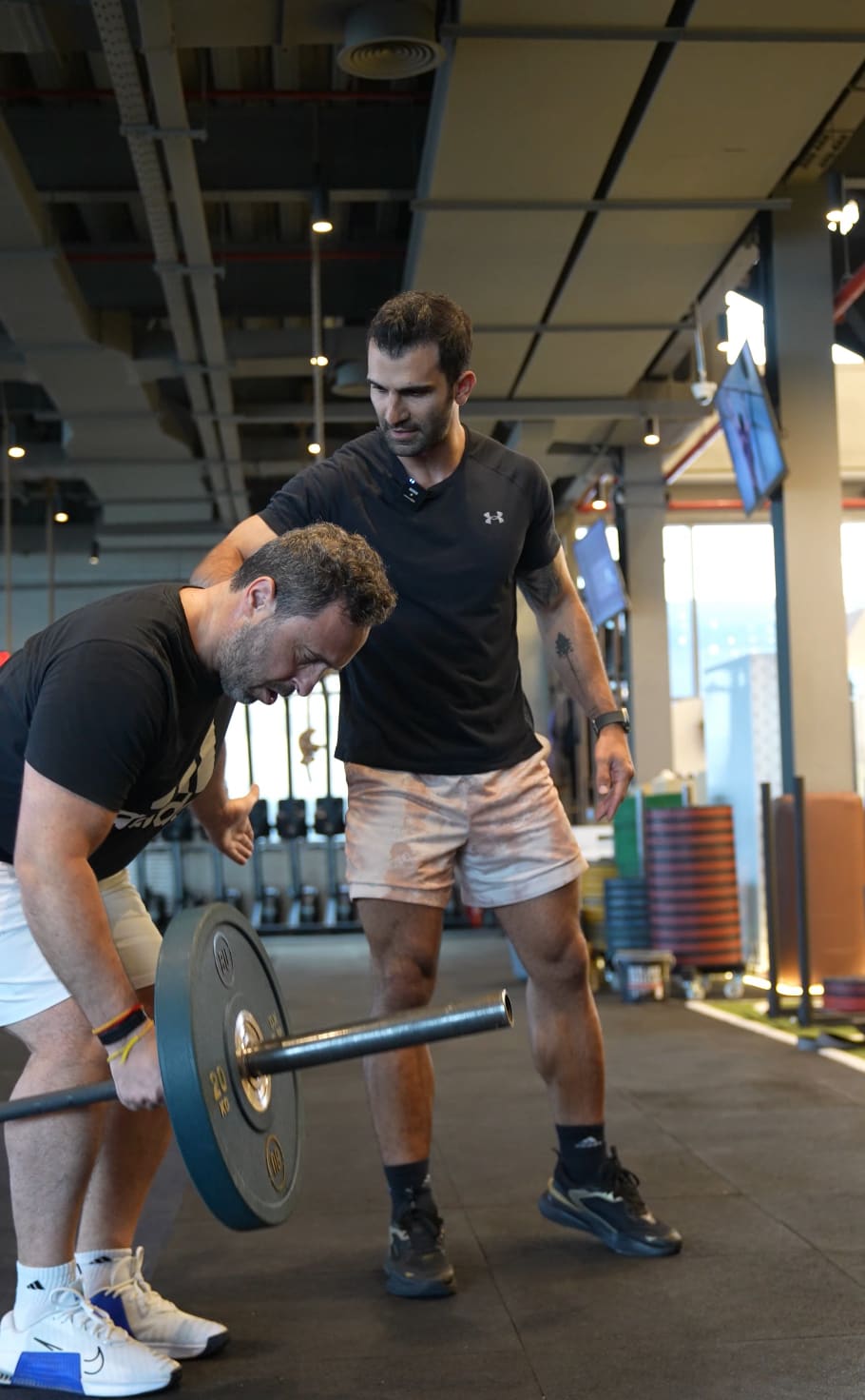 Coach guiding a private deadlift session